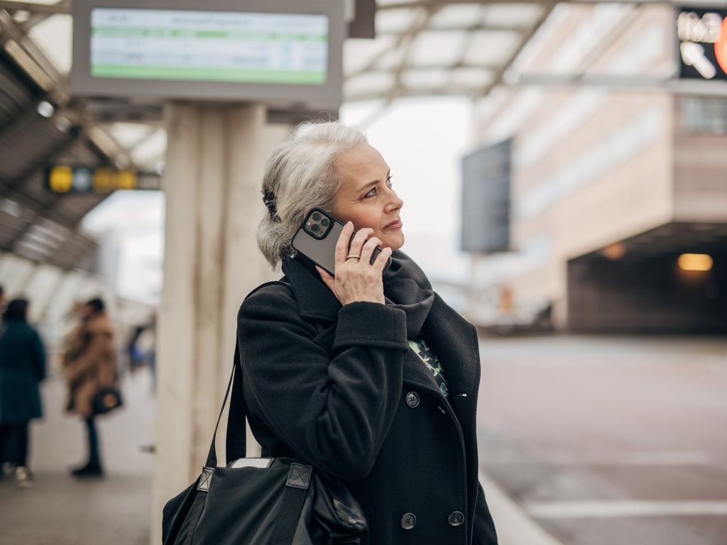 woman-talking-on-smartphone-train-station