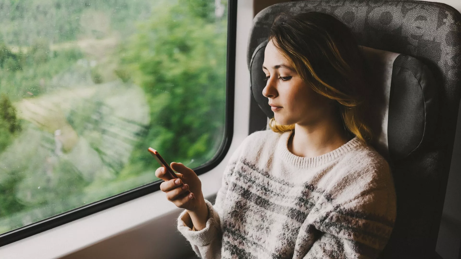 woman-using-phone-on-train